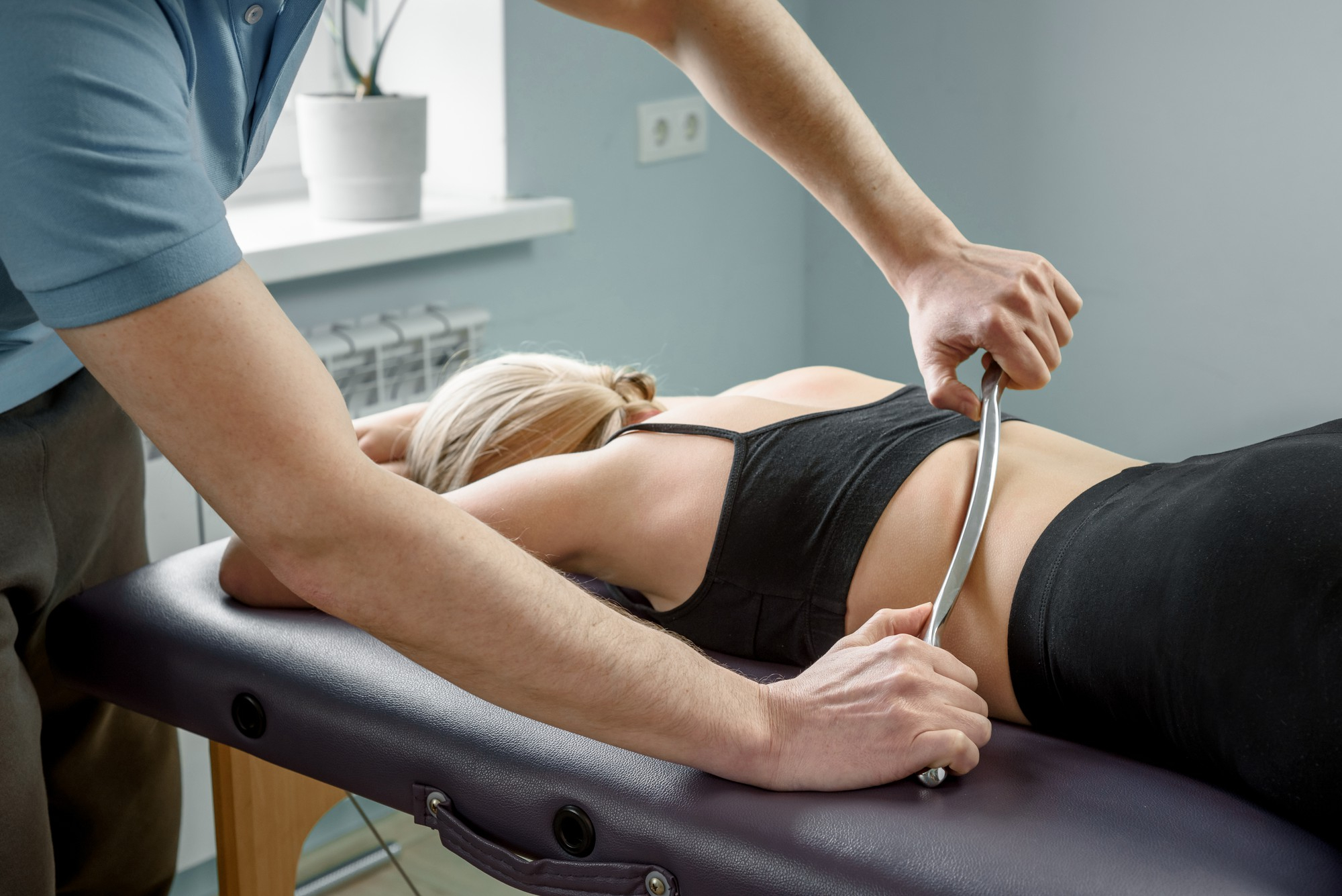 Physiotherapist assisting a patient with a shoulder stretch